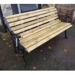 A garden bench with cast iron supports and slatted seat