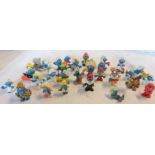 A small collection of 1960's and later PVC Smurfs by Schleich, most bearing the Peyo mark