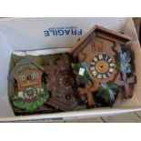 A box containing cuckoo clocks and others - various condition