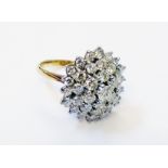 A marked 18ct yellow metal large concentric diamond cluster ring