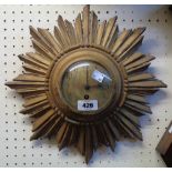 An early 20th Century giltwood cased sunburst dial wall timepiece with simple movement