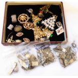 A case containing a quantity of good quality assorted gilt metal clasps, white metal and silver