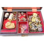 A jewellery box containing a quantity of costume jewellery rings, bracelets, brooches, etc.