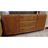 A 5' 1 1/4" Ercol polished elm sideboard with three central drawers and flanking cupboard doors