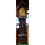 An antique ebonised and carved oak longcase clock, the 12" arched brass dial marked for John Oliver,