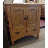 A 27" early 20th Century waxed pine two door cabinet with drawer under, set on simple square tapered