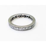 A white metal diamond set eternity ring