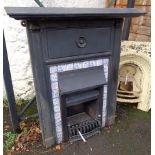 A late Victorian cast iron mantelpiece with insert blue and white tiled border