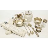 A collection of small silver items including two cream jugs, silver topped containers, napkin rings,