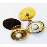 A pair of 9ct. gold oval panel cuff-links, each set with cabochon opal