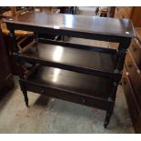 A 36" Victorian mahogany three tier buffet with turned supports and drawer under, set on brass