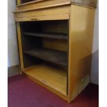 A 3' 3" vintage blonde wood and interior metal framed cabinet enclosed by a tambour