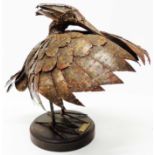 A patinated metal sculpture study of a Black Egret shade fishing, set on a polished socle base