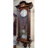 An early 20th Century polished walnut cased Vienna style regulator wall clock with visible