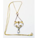 An Edwardian yellow metal seed pearl set open pendant on 9ct. gold fine-link chain