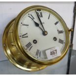 A vintage Schatz brass cased bulkhead clocks with eight day maritime bell striking movement