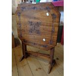 A 20th Century stained wood tilt-top occasional table with decorative foliate carving to top, set on