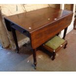 A 3' 5" Victorian mahogany Pembroke table, set on turned legs with brass caps and casters