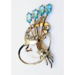 A 3 1/4" marked "sterling" gilt metal ornate brooch of open scroll and bulrushes design, set with
