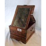 An antique Chinese vanity case with mirror to folding lid over two short and one long drawer, on
