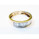 A marked 14KP yellow metal half eternity ring, set with sixteen baguette diamonds