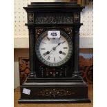 A late Victorian black slate and marble cased mantel clock with flanking metal Corinthian columns