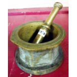 An antique heavy cast brass pestle and mortar