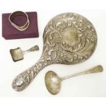 An Edwardian silver backed hand mirror - sold with a silver ladle, caddy spoon and boxed napkin