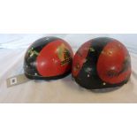 Two vintage motorcycle racing helmets, one bearing transfers for 1959 Isle of Man T.T. Races, the