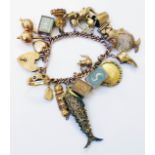 A 9ct. rose gold charm bracelet, set with various 9ct. and yellow metal charms including