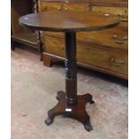 A 22 1/2" diameter later topped stained mixed wood pedestal table, set on a ring turned pillar and