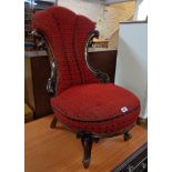 A Victorian mahogany part show frame nursing chair with fan back, flanking C-scrolls and piped red