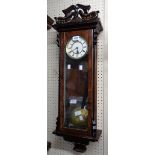 A 20th Century polished walnut cased Vienna style wall timepiece with visible pendulum and single