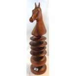 A turned, moulded and stained wood oversized knight chess piece - height 24"