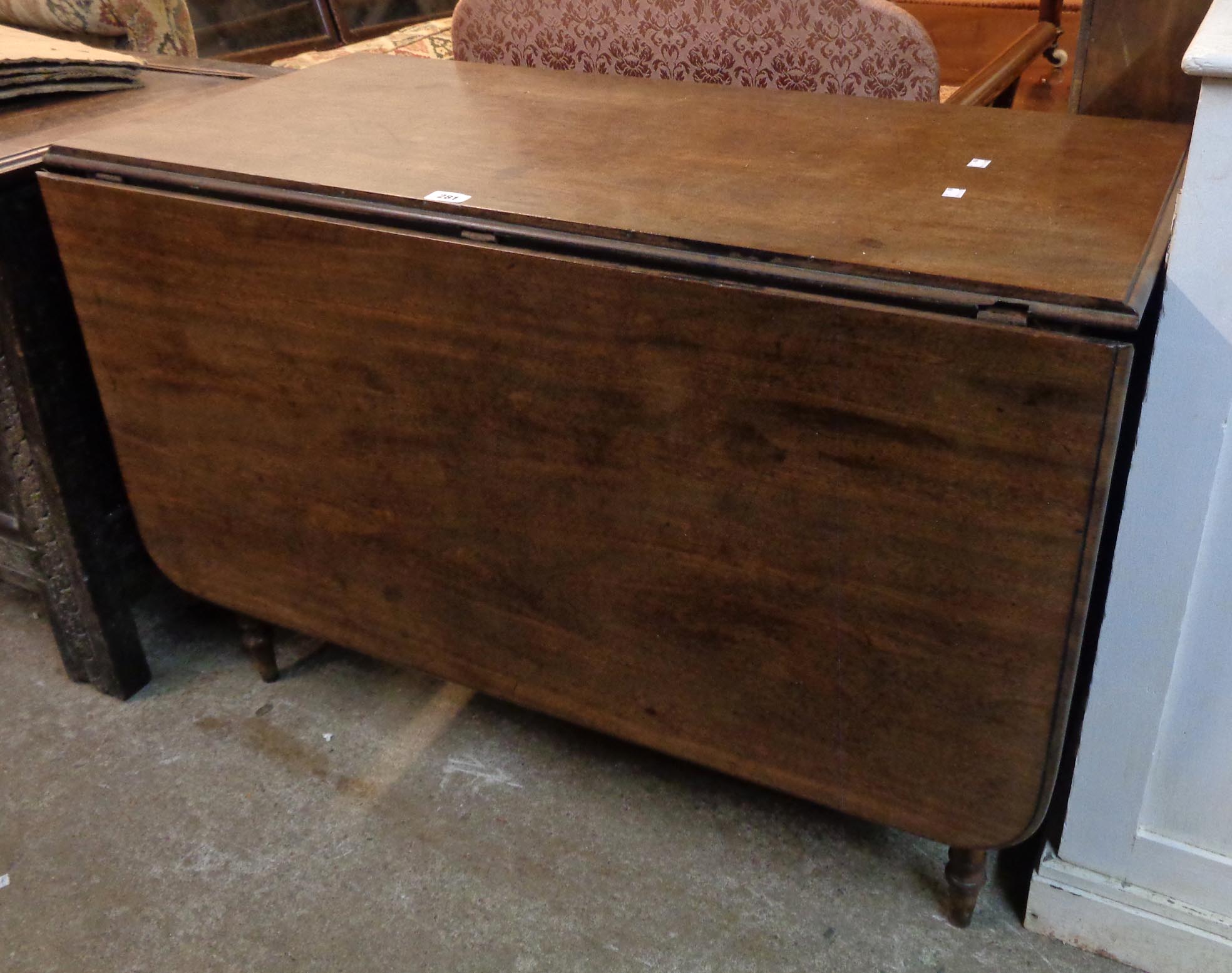 A 3' 6 1/2" 19th Century mahogany drop-leaf dining table with single gated action, set on ring