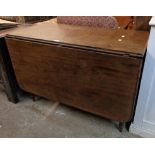 A 3' 6 1/2" 19th Century mahogany drop-leaf dining table with single gated action, set on ring