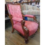An Edwardian polished oak part show frame drawing room armchair with red upholstery and incised