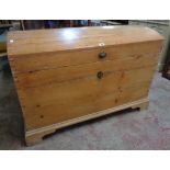 A 3' 10" antique waxed pine dome top linen chest with internal candle box and flanking heavy iron