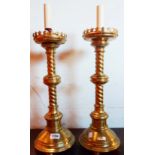 A pair of brass table lamps in the ecclesiastical style
