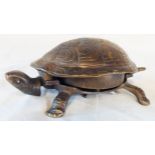A patinated brass call bell in the form of a tortoise