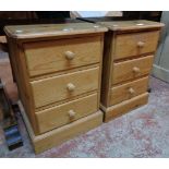 A pair of 17" pine bedside chests of three drawers, set on plinth bases