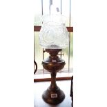 A vintage brass table oil lamp and moulded shade
