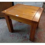 A 23 1/2" modern stained wood side table, set on moulded square legs