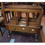 A late Regency mahogany Canterbury with shaped dividers and drawer under set on turned legs with