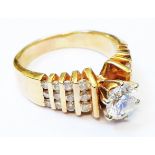 An early 1970's design marked 14k yellow metal ring, set with central 0.8ct. diamond with further