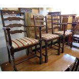 A set of six stained oak framed ladder back dining chairs with upholstered drop-in seats, set on