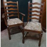 A set of four stained wood framed ladder back dining chairs with tapestry upholstered drop-in seats,