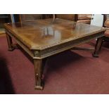 A 3' 4" reproduction quarter veneered strung and cross banded coffee table with canted corners,