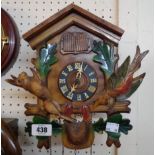 A 20th Century painted and polished wood cased cuckoo clock with triple weight driven movement