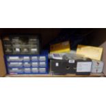 Two multi drawer storage units and a box containing a large quantity of clock making spares and